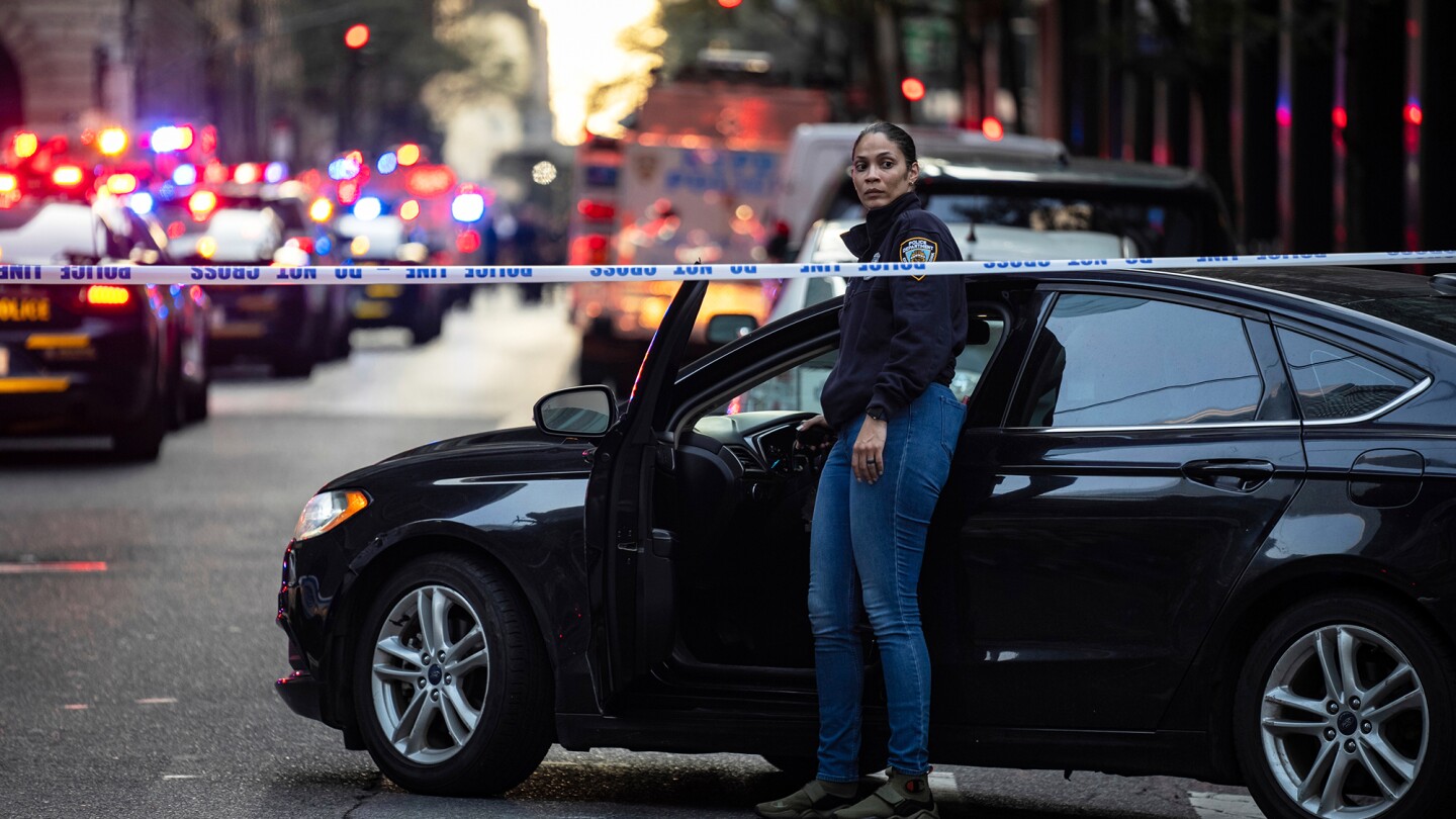 At least 2 people shot at Manhattan office building housing financial firms and NFL, source tells AP